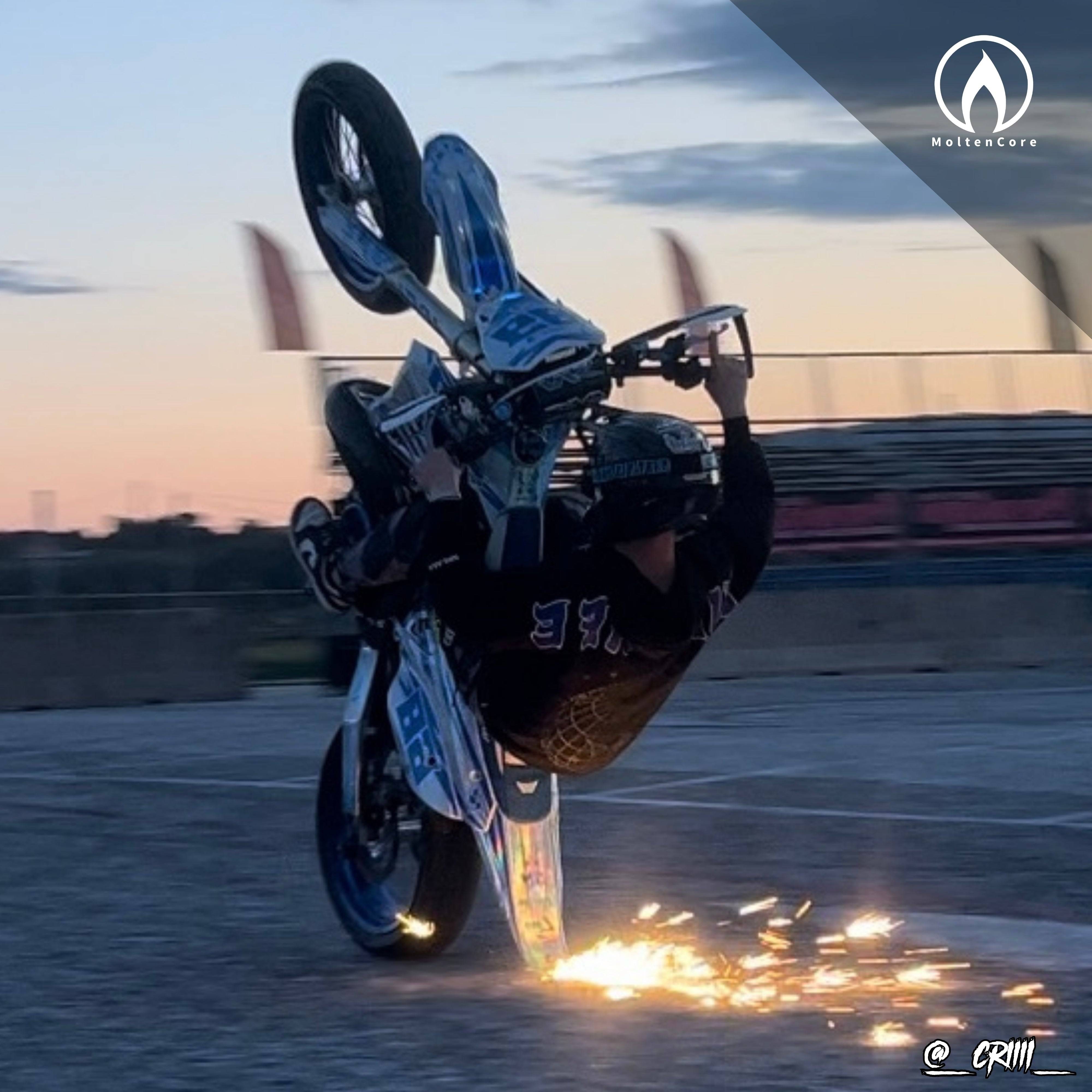 Motorcycle wheelie at dusk with FlareV5 TailScraper sparks